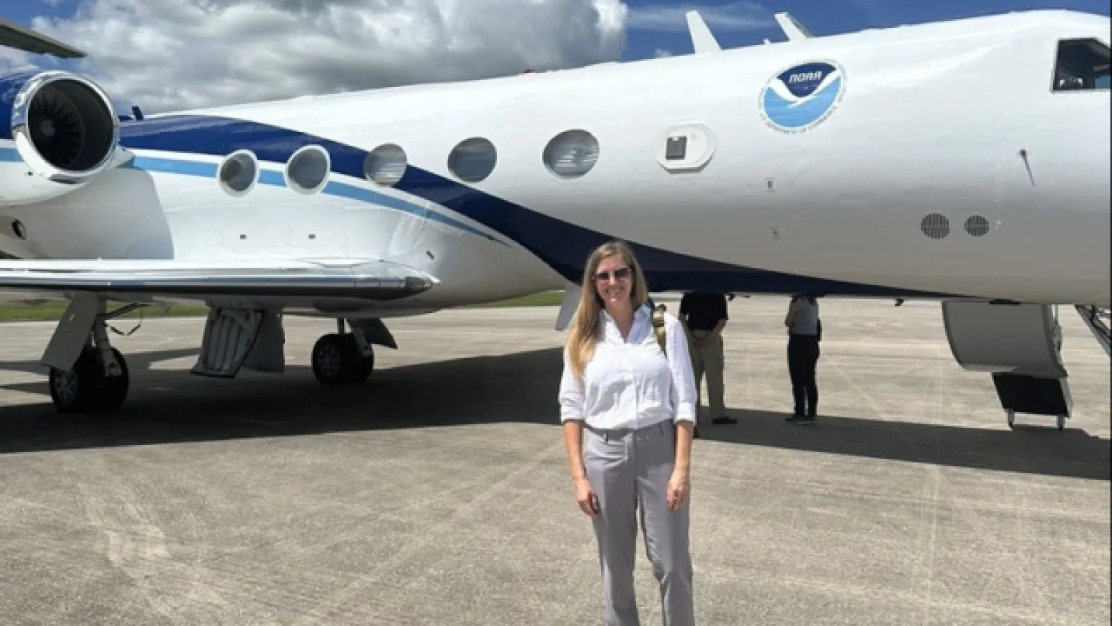 Chelsea Hunter in front of NOAA aircraft.