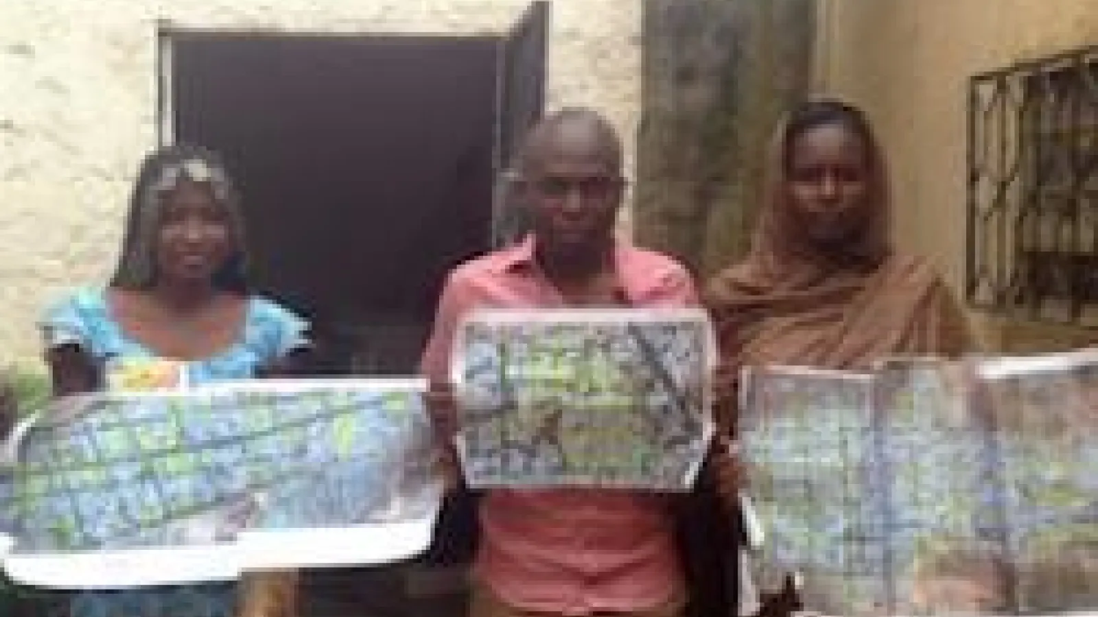 Assistants holding community maps