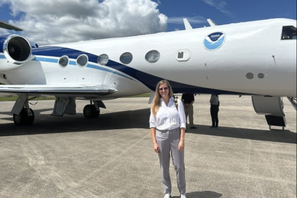 Chelsea Hunter in front of NOAA aircraft.